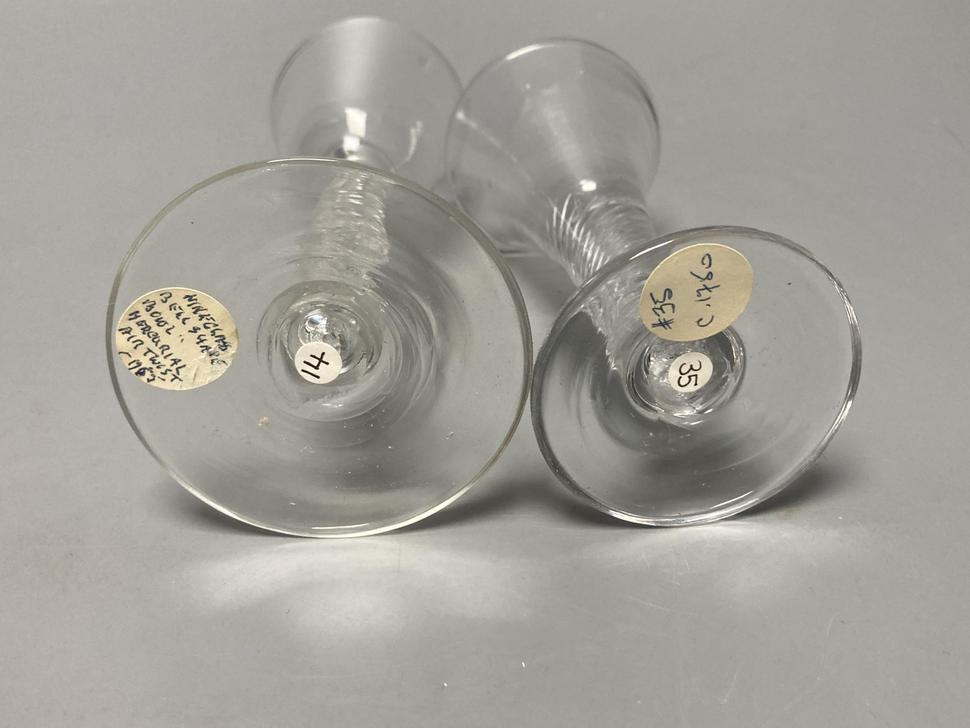 Two George II mercurial air twist stem cordial glasses, c.1750-5, with funnel and drawn trumpet bowls, 15.1cm and 12.4cm